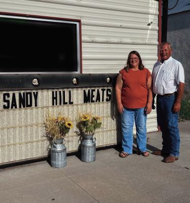 Russ and Lisa Gerlach are pictured at front of their shop, Sandy Hill Meats, in downtown Maywood.
