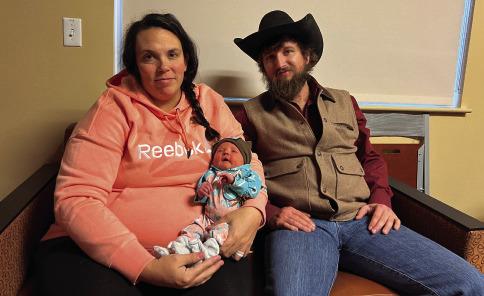 Nicole and Tyrel Kerchal sit with the first baby born in 2024, Oakleigh Rein Kerchal. Oakleigh was born on Jan. 3 at 11:47 p.m.