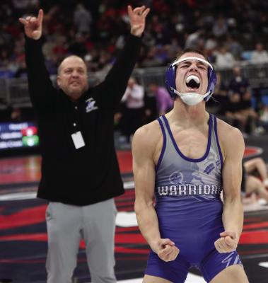Arapahoe’s Briggs Hill gets emotional after a semifinal victory while his father and coach, Cody, celebrates as well.