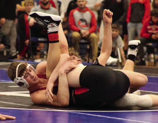 Hi-Line’s Grady Schutz spladles his opponent for a pin Saturday.