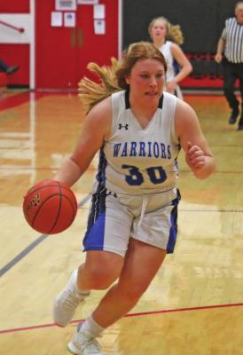 Arapahoe’s Gentry Warner drives the floor after a steal.