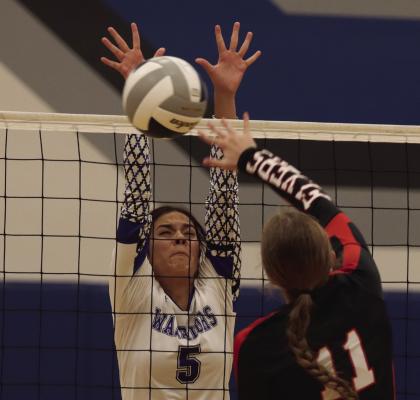 ABOVE: Naomi Gutierrez blocks a Franklin attack. BELOW: The Warriors’ Emerson Swanson digs a ball off the floor.