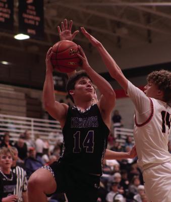 Arapahoe’s Ander Wasenius scores around a Cambridge shot-blocker.