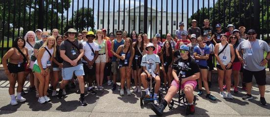 The students pose for a picture in front of the White House.
