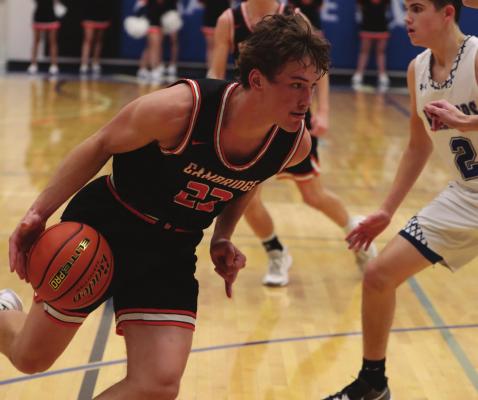 Cambridge’s CJ Fiene drives into the paint.