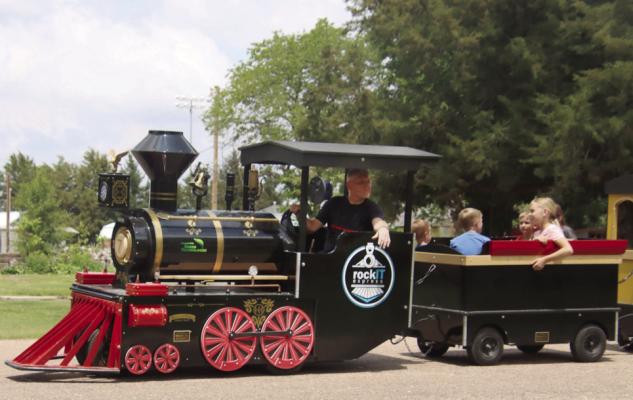 Kids enjoys their time in the sun while riding the train at the park in Bartley.