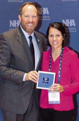 Nebraska Hospital Association President Jeremy Nordquist presents the Caring Kind Award to Karinne Kulwicki, PA-C, Tri Valley Health System’s Honoree, at the Nebraska Hospital Conference last week.