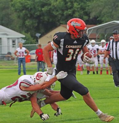 ABOVE: Cambridge’s CJ Fiene makes a catch and turns up field aginst Amherst Friday night. BOTTOM: Arapahoe’s Tyler Miller snags a two-point conversion that puts the Warriors in front of Lawrence-Nelson for good Friday night.