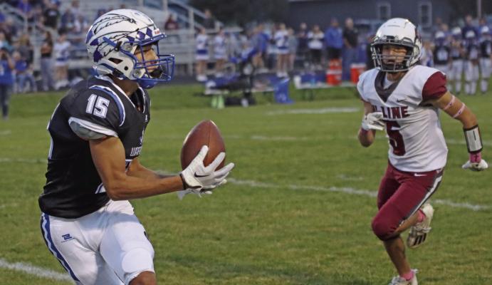 Arapahoe’s Alex Diaz reels in a catch and takes it in for the first score of Friday’s game.