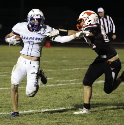 Arapahoe’s Will Cacy tries to get around the corner against a Stanton defender.