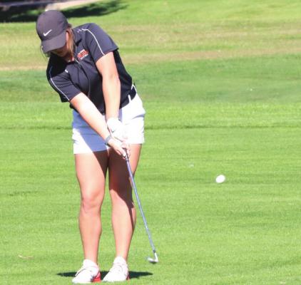 Cambridge’s Macy Jones chips onto the green during her seventh-place finish at the District C-4 Tournament Monday.