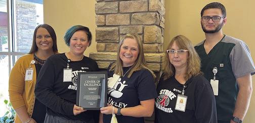 The Tri Valley Health System Advanced Wound Care received the prestigious Center of Excellence Award for exceeding the highest level of clinical and quality standards in healing rate, patient satisfaction, and median days to heal. Pictured with the award are: Jessica Fisher, Chief Executive Officer; CJ Einsphar, RN; Sally Farquhar, APRN; Kenda Ekdahl, RN; and Clay Jordan, Chief Nursing Officer.