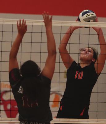 The Trojans’ Jacey Kent two-hands a ball over the Hi-Line block Friday.