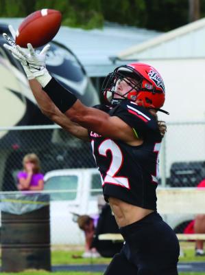 The Trojans’ Will Taylor snags a deep pass for a touchdown Friday against Pleasanton.