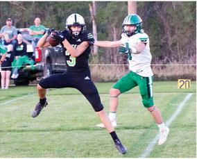 The Wolves’ Charlie Callis intercepts a pass.