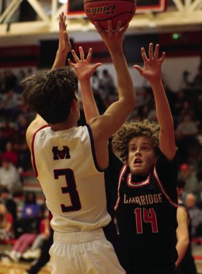 Cambridge’s Brady Ahlemeyer challenges a jumpshooter.