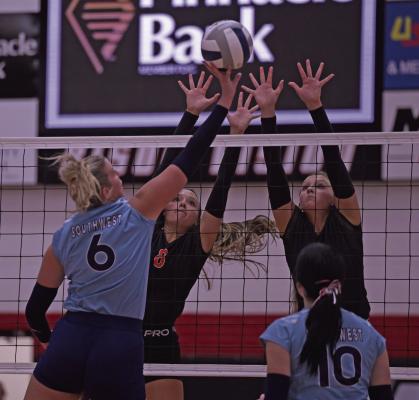 Southwest’s Kyra Nelms tips around the Cambridge block during Saturday’s semifinal win.