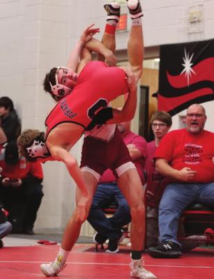 Hi-Line’s Wryston Brell lifts his opponent for a takedown.