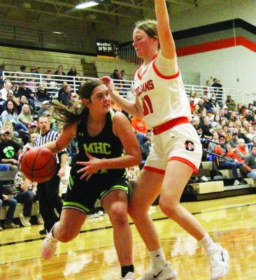 MHC’s Aubrey Broz drives against Cambridge defender Erin Johnson.