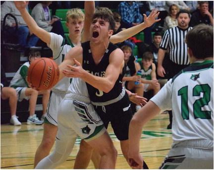 Southern Valley’s Kamden Bose fights toward the hoop as he drives into a Loomis defender.
