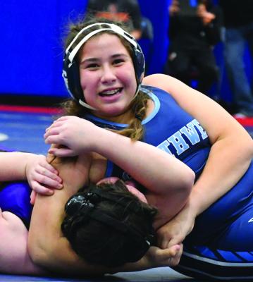 Southwest’s Madelyn Tryon completes a pin with a smile.