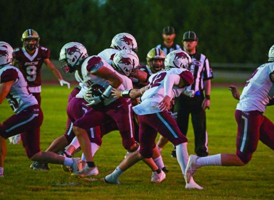 Hi-Line’s Kane Cochrane hands the ball off on a misdirection play.