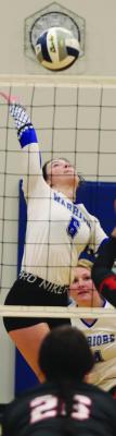 Arapahoe’s Rylee Bahe attacks a ball from the right side.