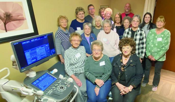 Cambridge Hospital Auxiliary members shown with the new ultra sound machine and bed which they gifted with $59,000. front (l-r) Georgia Dutt, Betty Kruger, Linda Sandman; row two, Marilyn Klinkebiel, Charla Mehaffie, Elnora Burke, Sharon Lightle; row three, Pat Downer, Linda Johnson, Jaccie Morgan, Charlene Young; back: Ross Ebbers Imaging Director, Vicki Jones Volunteer Coordinator, Joy Deterding, Jessica Fisher CEO, Dean Sprinkle and Breanna Witte Imagining Techs.