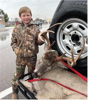 This youngster proudly poses with his first buck while checking in at Wagner’s Supermarket in Arapahoe on Monday, November 18.