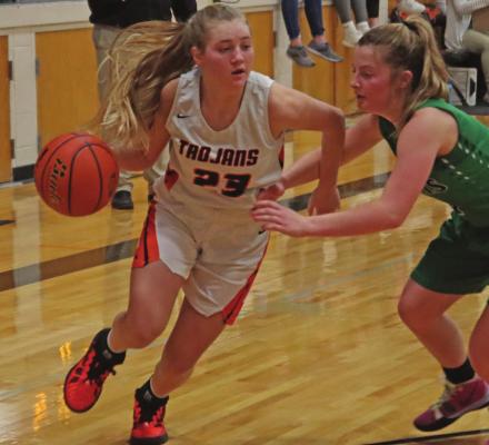 Cambridge’s Breelle Miller drives into the lane.