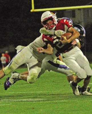 The Eagles’ Mason Noel brings down a Alma ball carrier.