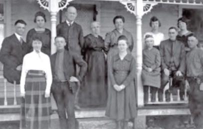 Edwin Perkins and family in Hendley, NE, circa 1920. Back row, L to R: Edwin Perkins, Kitty Perkins, David Perkins (father), Sophia Haymaker (grandmother), Kizzie Haymaker Perkins (mother), Far Perkins Morrow (sister), and Beatrice Perkins (sister). Front row, L to R: Vesta Perkins (sister), Ivan Perkins (brother), Wilma Perkins (sister), Alberta Perkins (sister), Dr. Carl Morrow (brother-in-law), and Frank Perkins (brother).