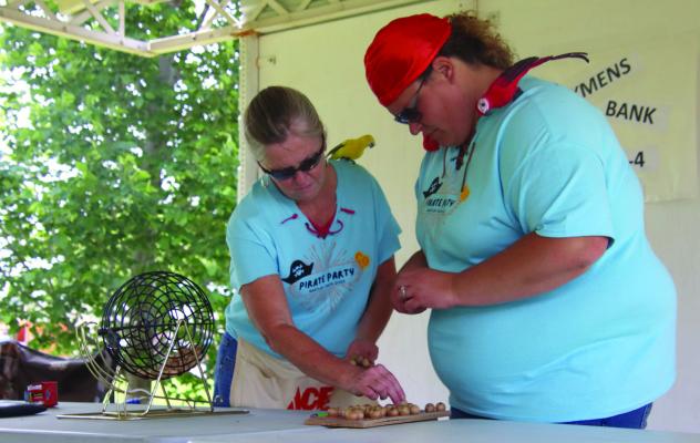 Volunteers from Stockmen’s bank make sure they have all the bingo balls they need.