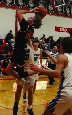 Cambridge’s Hodge Raburn soars toward the hoop after breaking through Ravenna’s defense.