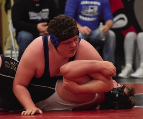 Arapahoe’s Jacen Smith earns a pin on his way to a fourth- place medal at Pleasanton Friday.