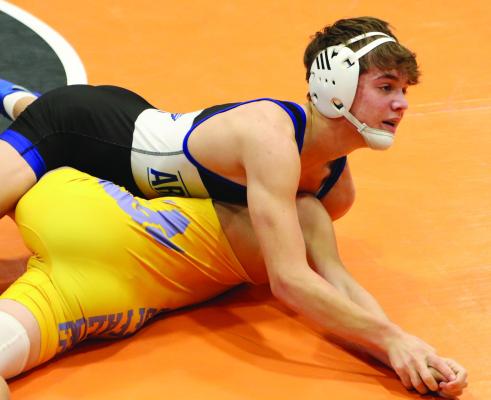 Arapahoe’s Briggs Hill earns a quick first-round pin on his way to a championship finish at Cambridge.