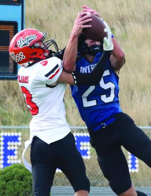 Cambrigde’s Hodge Raburn wrestles the ball away from an Overton defender for a touchdown.