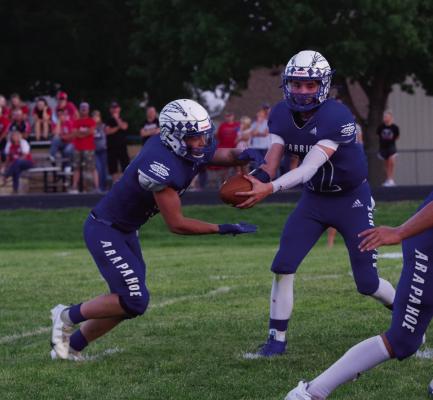 Arapahoe’s Trenton Roskop reads the defense at the mesh point with Rafe Hill.