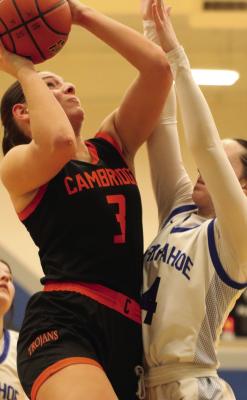 Cambridge’s Mallory Springer rises to score inside against the defense of Arapahoe’s Ryleigh Tidyman during their contest Tuesday at Arapahoe.