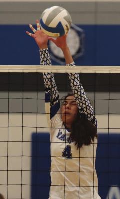 Arapahoe’s Naomi Gutierrez blocks back an attack.