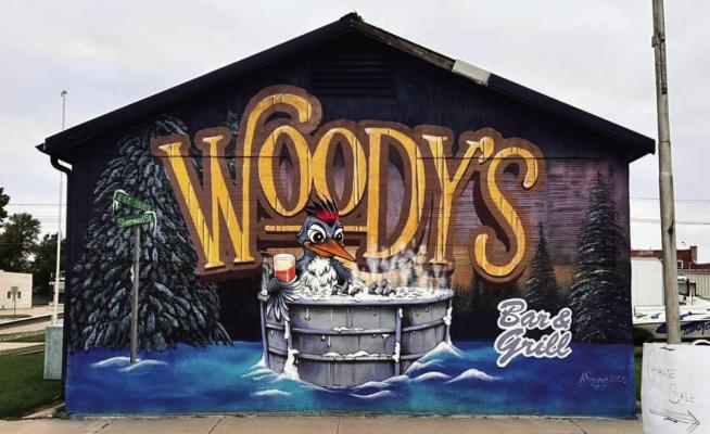Artabyss Design Studio paints mural for Woody’s Bar & Grill