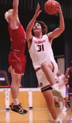 Dahlton Wood powers up for a layup versus a smaller defender from the West. Photo by Diane Stamm.