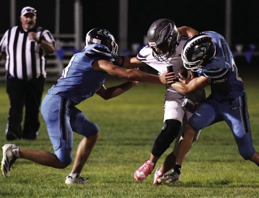 Southwest’s Bo Truksa and Jacob Barber bottle up the Garden County ballcarrier. Southwest held Garden County to just 56 yards rushing Friday night.