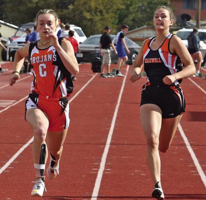 ABOVE: Cambridge’s JoLie Farr sprints to gold in the 100 dash. 