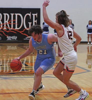 Southwest’s Zack Ryan drives into the lane against Cambrigde’s Will Taylor.