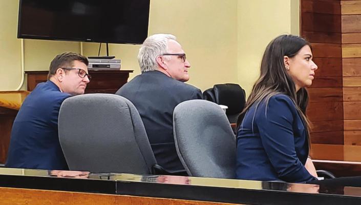 Surrounded by his defense attorneys, Oxford’s Billy Quinn hears the verdict from a two-week jury trial, where he was convicted of 13 of 14 felony counts.