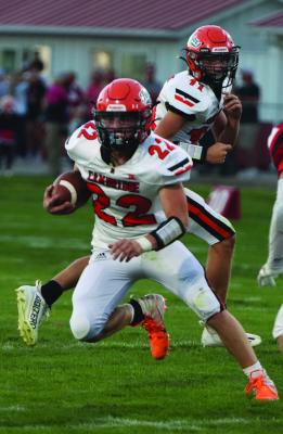 The Trojans’ Tye Stanton looks for running room.