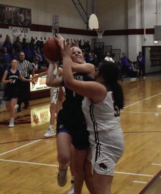 Arapahoe’s Emma Strand challenges Hi-Line’s Malia Viter on a transition layup.