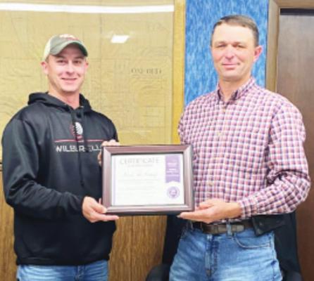 Oxford - Longtime Village of Oxford board chairman (pictured right) is presented a certificate of appreciation by Vice-Chairman Clint McQuiston for his 20 years of service.