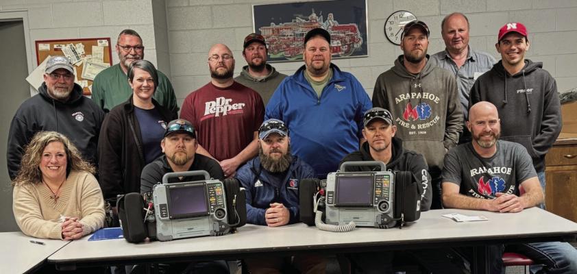 Shown with new monitors for the Arapahoe Ambulance are Front row L-R Amy Huxoll, Colby Carpenter, Josh Schrock (Asst. Chief), Mitch Houser, Peter Leising. Middle row: L-R John Paulsen (Chief), Stef Hoefs, Elliot Hoefs, Wendall Hoefs, Frank Leising, Logan Dettmann. Back Row: Todd Monie, Brandt Kresser, Arlan Leising.